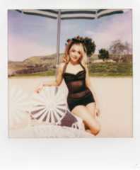 Image may contain Sabrina Carpenter Face Head Person Photography Portrait Clothing Swimwear Summer Adult and Dress