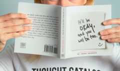 Person Holding a Book in Front of their Face