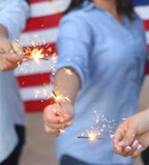 People Holding Lit Sparklers