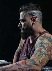 Person with Tattoos on Arms and back of the Head