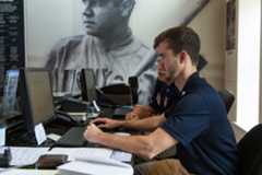 A Hall of Fame employee at the Museum information Desk