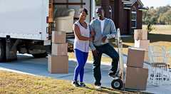 couple stands in front of moving truck