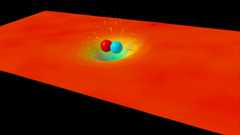 A visual simulation of two objects orbiting and merging, distorting a red-orange grid representing spacetime—illustrating gravitational waves once thought to be the worst prediction in science.