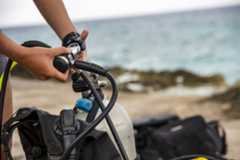 A scuba diver setting up a set of regulators, who might use diving terms such as octopus or demand valve to describe them