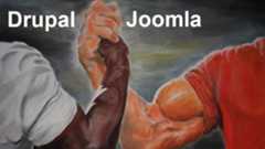 A pair of armwrestling hands, one labelled Drupal and one Joomla.