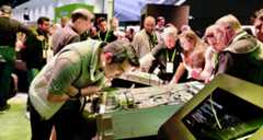 GTC attendee looking at hardware in the NVIDIA booth