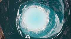 a circular hole in the middle of a mountain