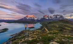 Hiker looking towards snow-capped mountains