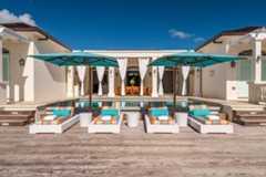 Poolside loungers with umbrellas and a bright back