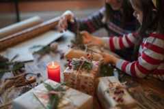 Mother and daughter wrapping holiday gifts