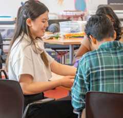 Teens sitting at a table studying.