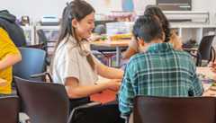 Teens sitting at a table studying.