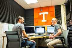 Alum Doug Alder and his partner Eric Middleton laugh together in the WUTK studio.