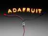 Demo Shot of the Constant Current Boost Converter powering LED Letter Filaments that spell out "Adafruit".