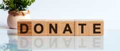 Wooden blocks spell 'DONATE'
