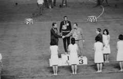 The three winners of the men's 200 metres dash mount the rostrum at the World University Games in Tokyo, held at the Universiade, 7th September 1967. From left to right, they are Britain's Menzies Cambell, T. Smith of the USA, and Italy's I. Giani. © Keystone/Hulton Archive/Getty Images