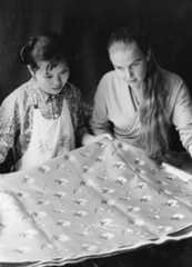 A foreign visitor admiring the silk made in a factory in Hangzhou in 1975 ©Getty Images