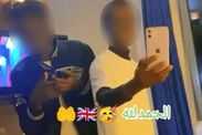 Supposed asylum seeker holds up phone during party