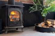 Any households with log burners must make one check this year Firewood near black metal fireplace in cozy living room