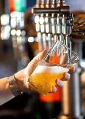 Pub giant Greene King plans massive restructure - 100 jobs at risk Pouring a Pint in a Bar