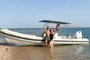 Shelley and her husband standing next to a boat