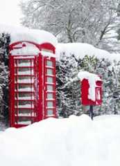 Red telephone and post box in the snow