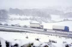 Traffic On Motorway During Snowstorm