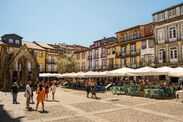General view of the olive tree square in guimarães with several tourists