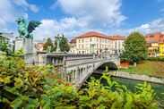 The pedestrian Dragon Bridge, or Zmajski Most, over the Ljubljanica River, in the historic old town center of Ljubljana, Slovenia at summer.