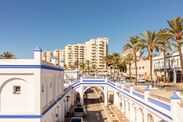 Estepona, Malaga, Andalusia, Spain. 3 September 2025. White and blue arches with palm trees and buildings