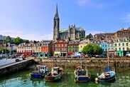 Colorful buildings, old boats and cathedral, Cobh harbor, County Cork, Ireland