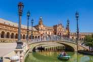 Tourists enjoying a boat ride in the canals of the Plaza Espana in Sevilla