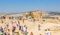 A large crowd of people are gathered on a ruins.