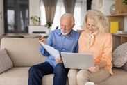 HMRC issues pensions warning as 'helpful advice' could be costly Elderly Couple Engaged in a Discussion with Tech