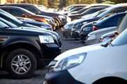 Lots of cars in an open parking lot, selective focus