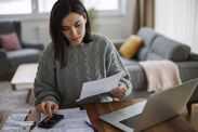 Woman checking her monthly expenses and statements at home