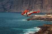 Canary Islands threatens fines for ‘reckless’ tourists after Tenerife deaths Rescue helicopter flies over a stormy ocean near rocky coastline in Tenerife