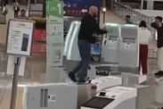 Screengrab of British man, 35, smashing up check-in kiosks at Hong Kong Airport