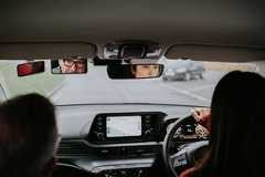 Driving instructor confirms what 'confusing' road sign actually means A learner driver practices on a wet road while an instructor observes from the passenger seat.