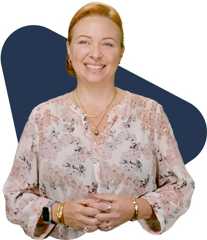 Amy howells ocean v4 Smiling woman with reddish-blonde hair in floral blouse and jewelry.