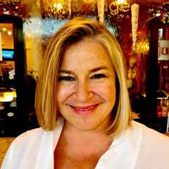 Julia sonnichsen square Julia sonnichsen smiling in a white top indoors.