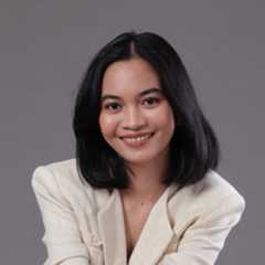 Young woman with black hair wearing a blazer and necklace