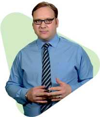 Man in blue shirt and tie, hands clasped, abstract background.