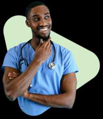 Young male doctor in blue scrubs with stethoscope, smiling thoughtfully.