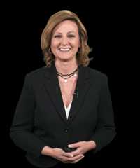 Christy davidson wearing a black blazer and layered necklaces.