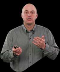 David spade, bald, gray shirt, gesturing, green background