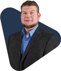 Thad wilson, educator, smiling in a dark blazer.