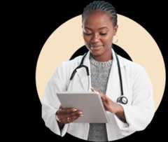 Female medical professional smiling while looking at tablet