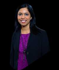 Hetal Verma wearing a black blazer over a purple blouse.