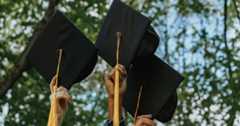Students holding up their graduation caps